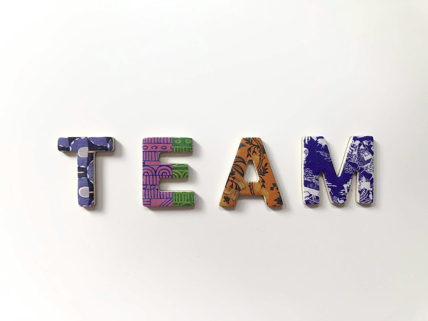 team spelled out in block colored letters on white background