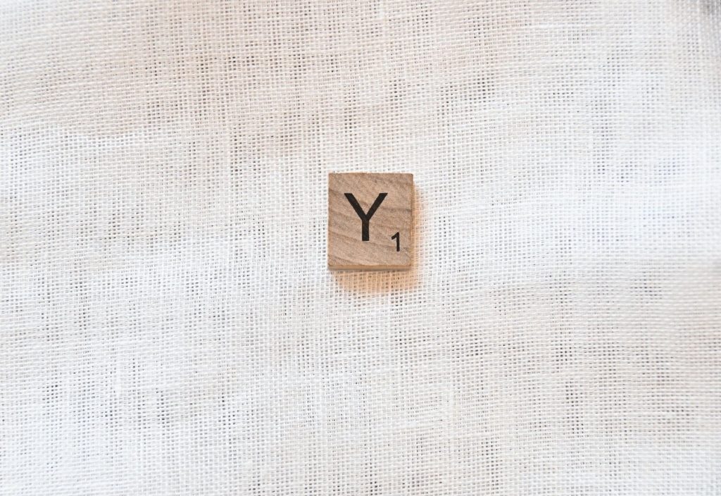 the letter Y on a wooden tile