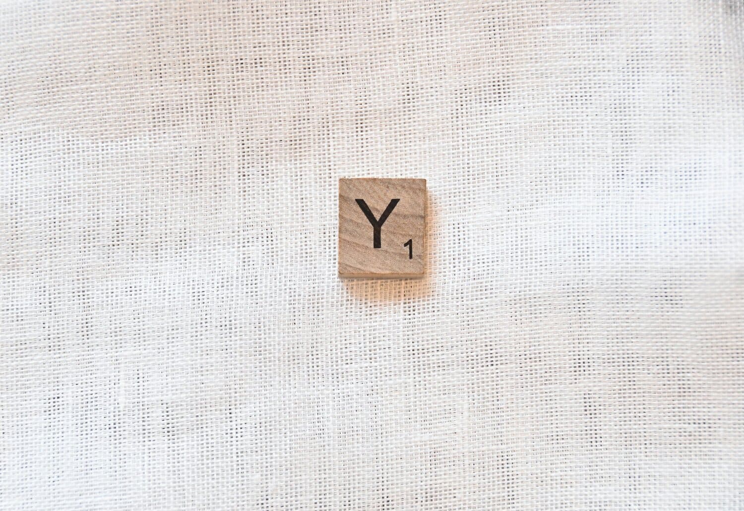 the letter Y on a wooden tile