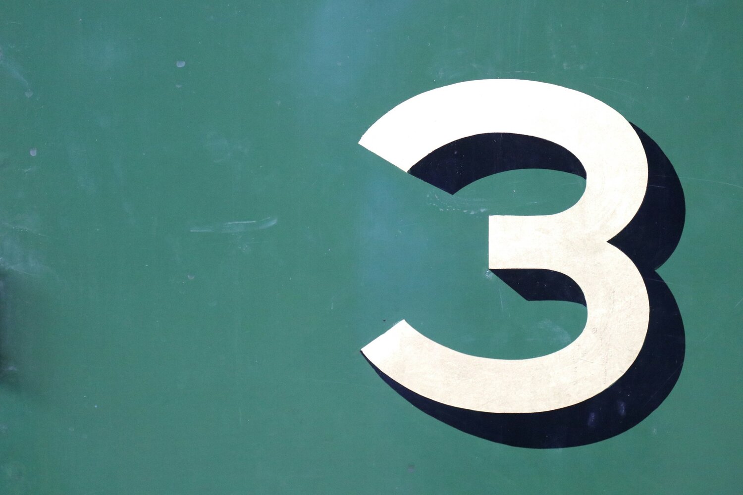 the number 3 against a green background