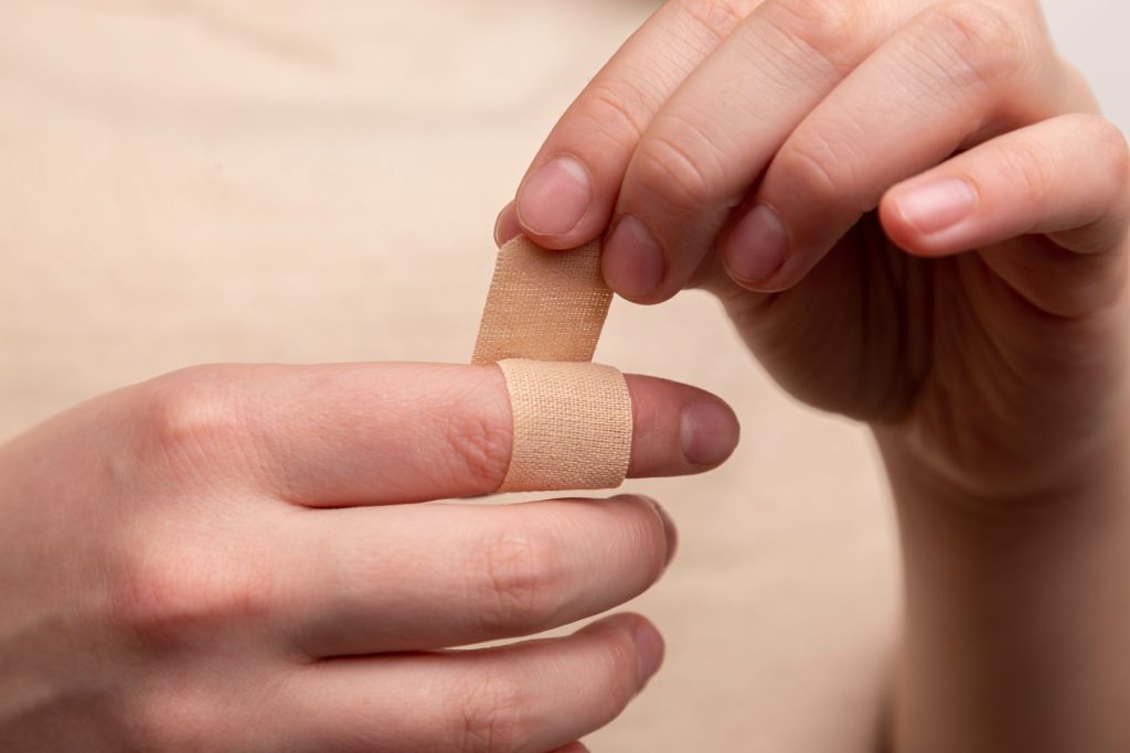 wrapping bandaid on finger