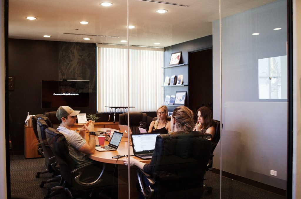 people sitting around a conference table in a meeting