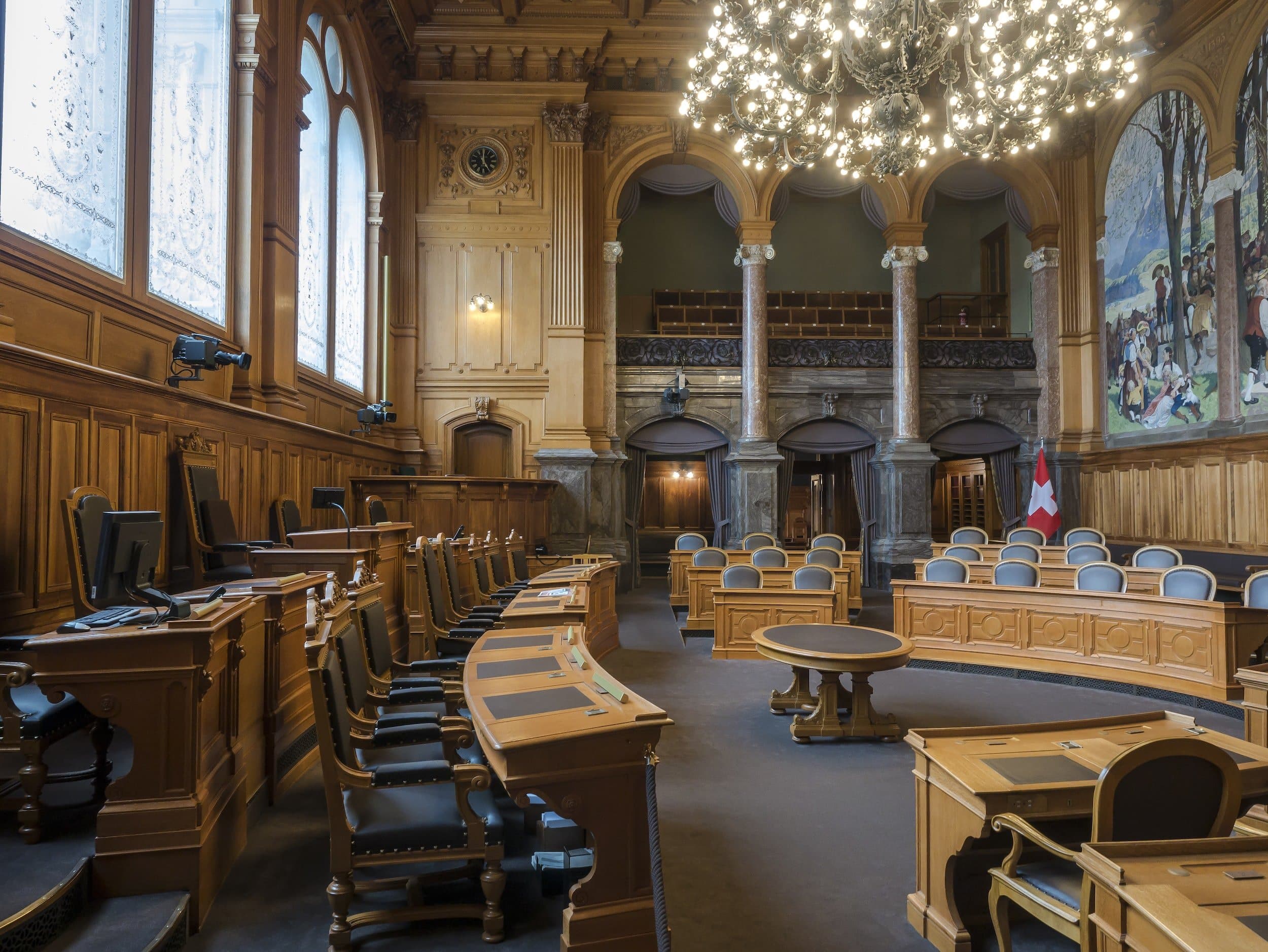 inside courtroom with crystal chandelier and windows