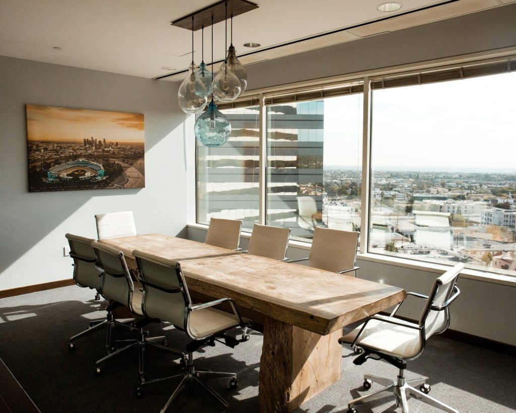 office setting with conference table and chairs with window in background