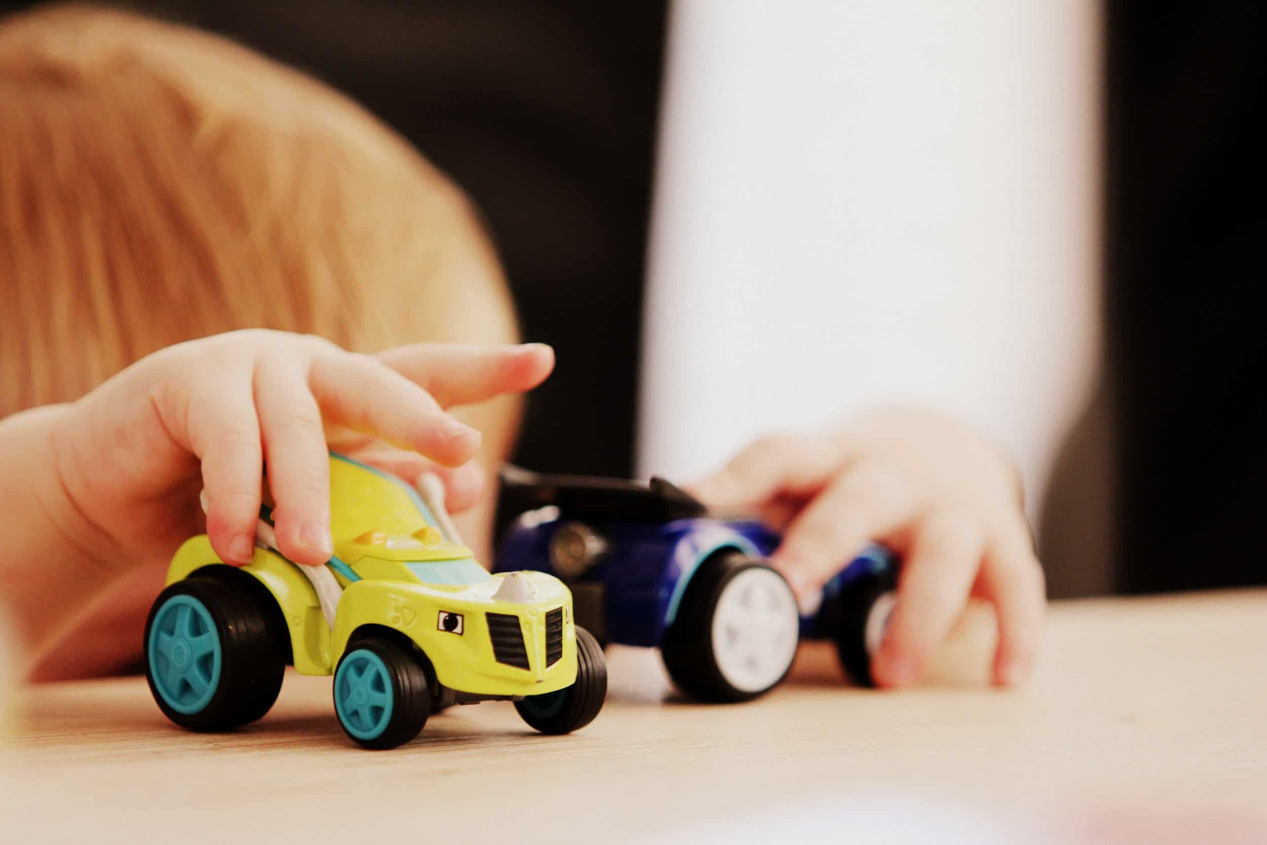 child playing with toys cars