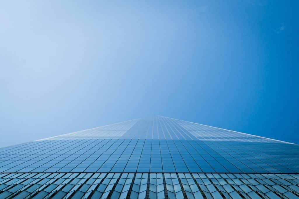 tall mirrored building with blue sky