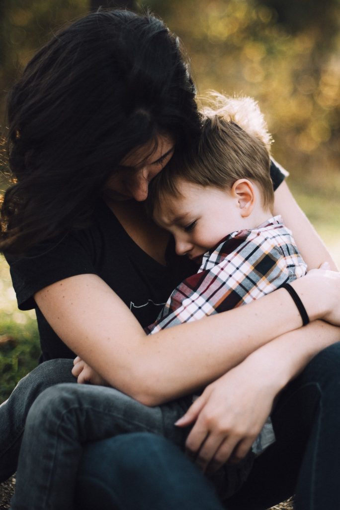 mother hugging small boy