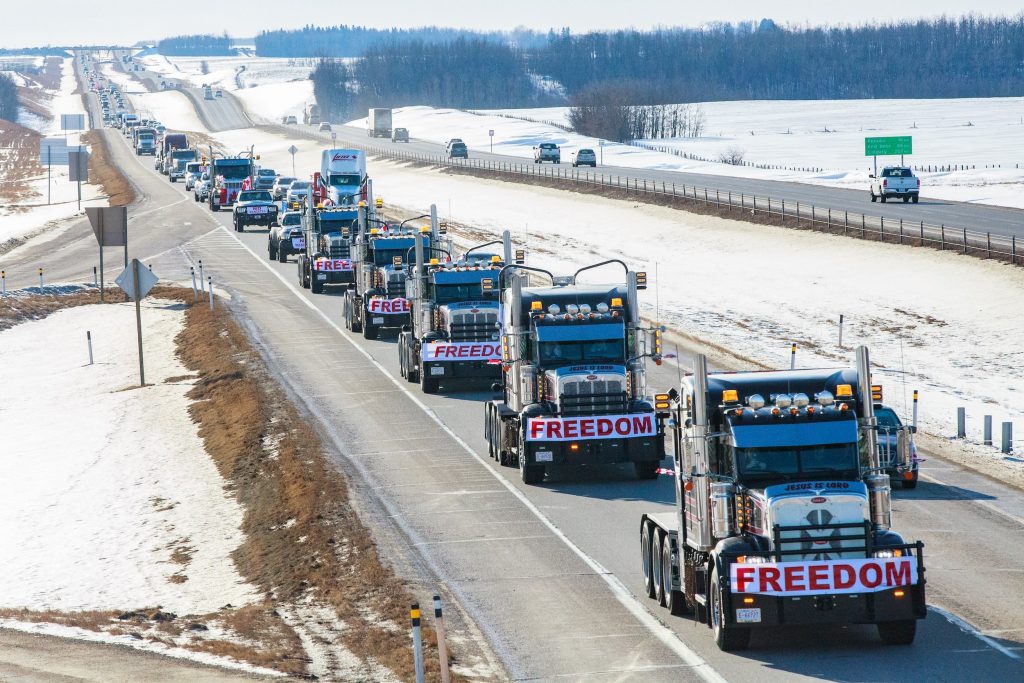 trucks on a highway with freedom banners