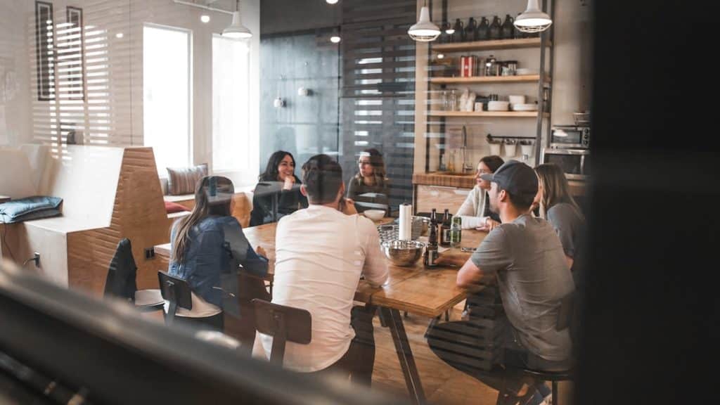 group of people sitting around a workplace